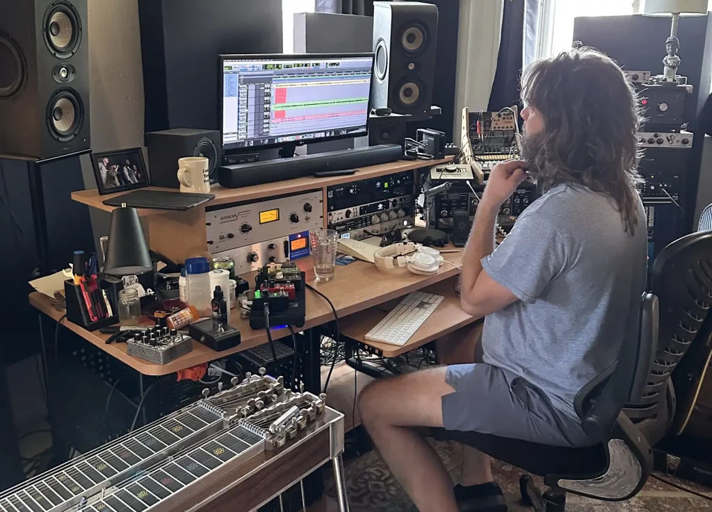 band member mixing music on computer