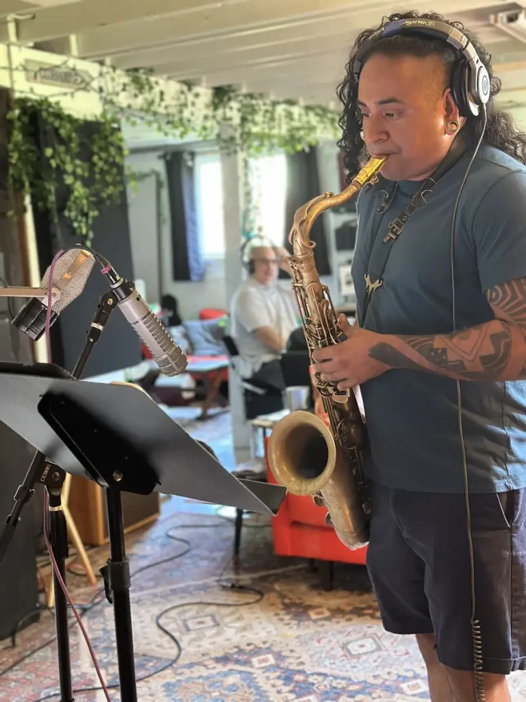 Armando playing the saxophone reading sheet music