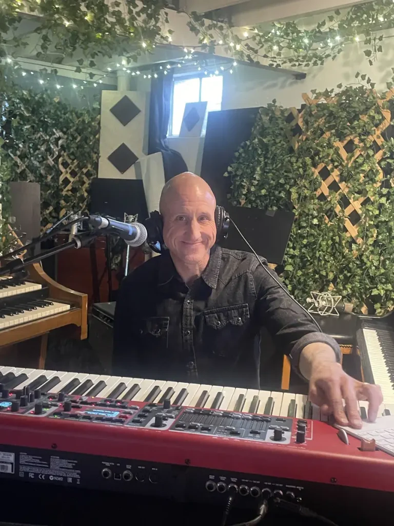 Jon smiling with his keyboard